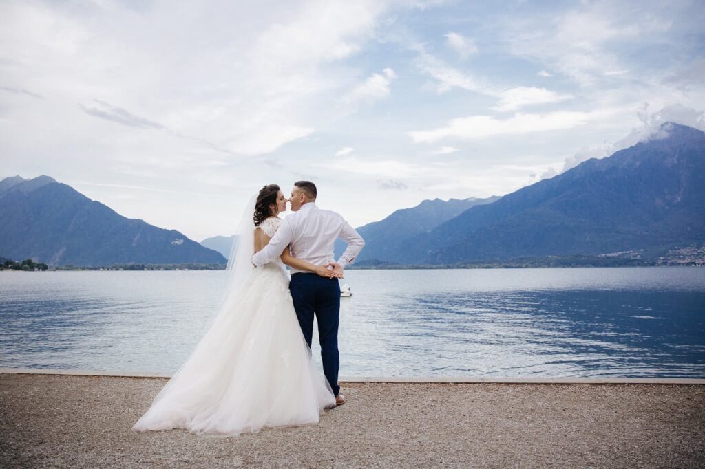 Bride and groom share a romantic moment by Lake Como in Menaggio, Italy.